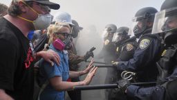 Protesters confront police on the 101 Freeway near the Metropolitan Detention Center of downtown Los Angeles, Sunday, June 8, 2025, following last night's immigration raid protest. (AP Photo/Jae C. Hong)