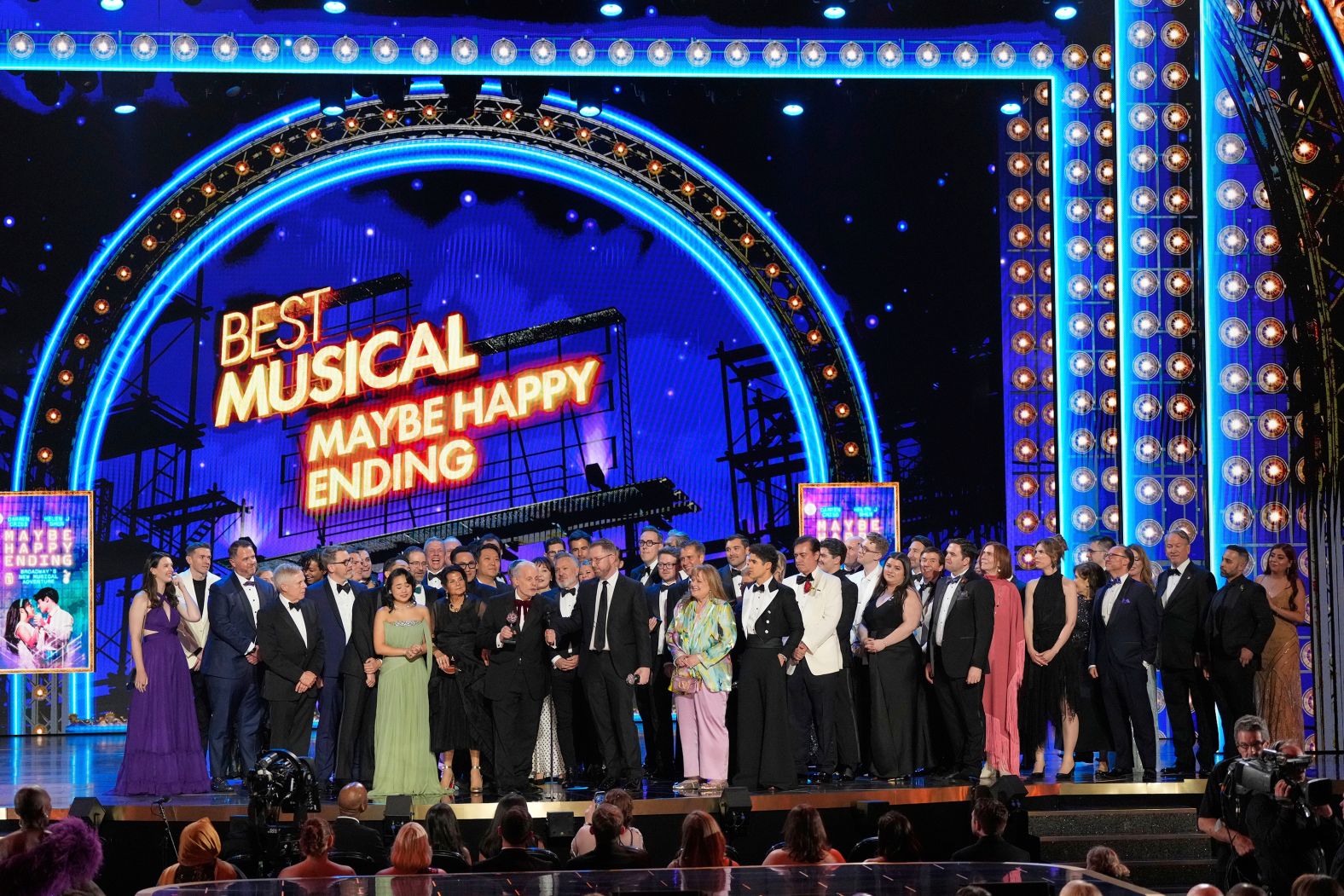 The cast and crew of "Maybe Happy Ending" accept the award for best musical.