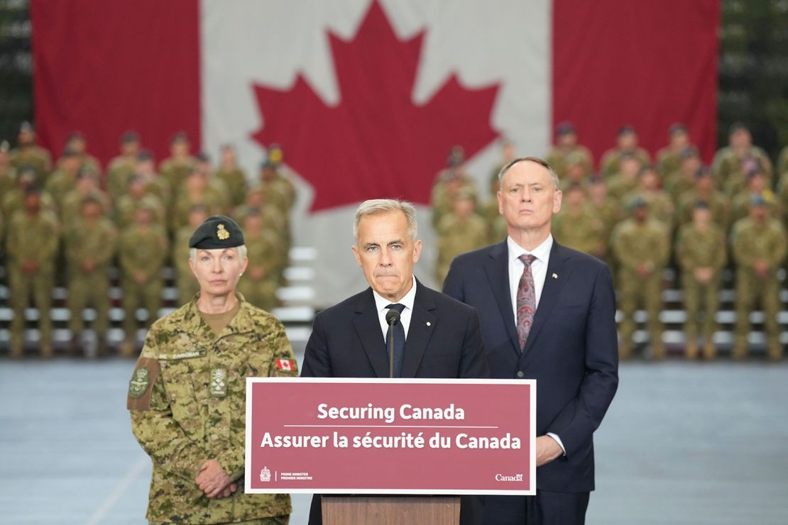 Canada Prime Minister Mark Carney stands with Minister of National Defence David McGuinty, right, and Chief of the Defence Staff, General Jennie Carignan, left, in Toronto, Canada, on Monday, June 9, 2025.