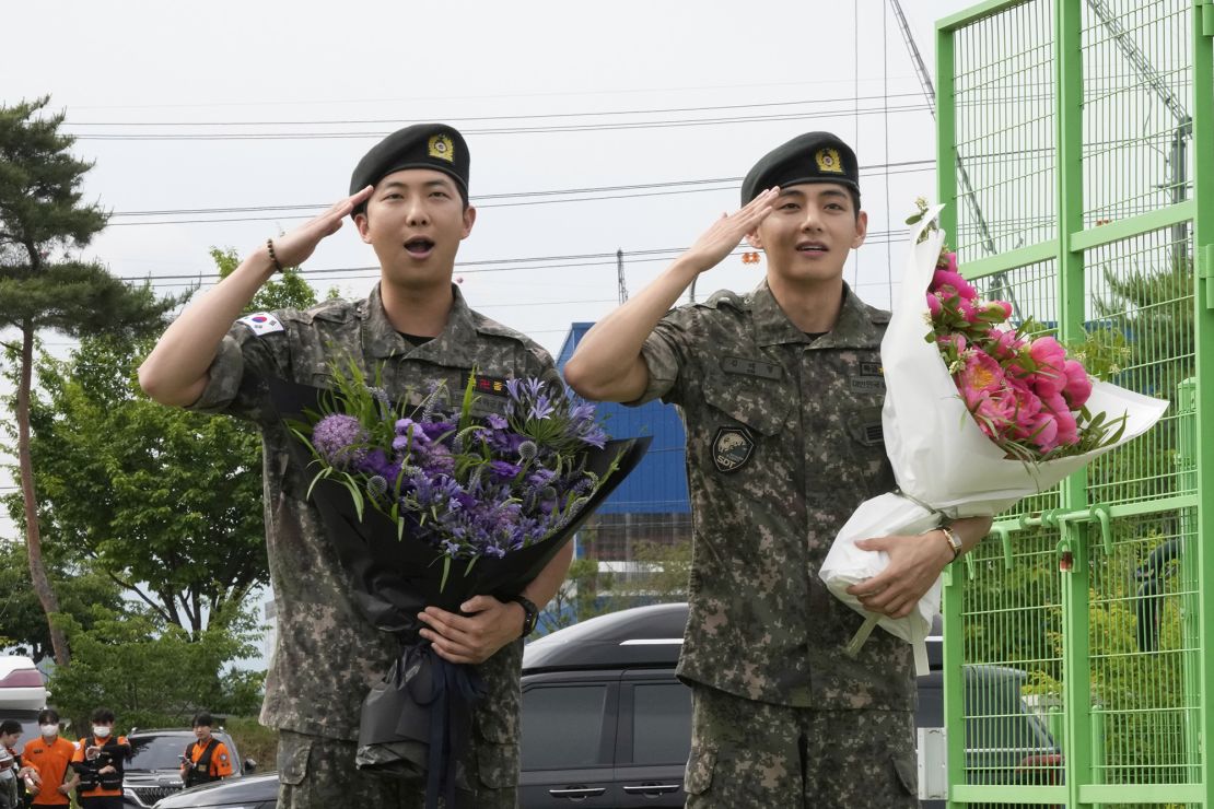 K-pop band BTS members RM, left, and V salute after being discharged from a mandatory military service in Chuncheon, South Korea, Tuesday, June 10, 2025.