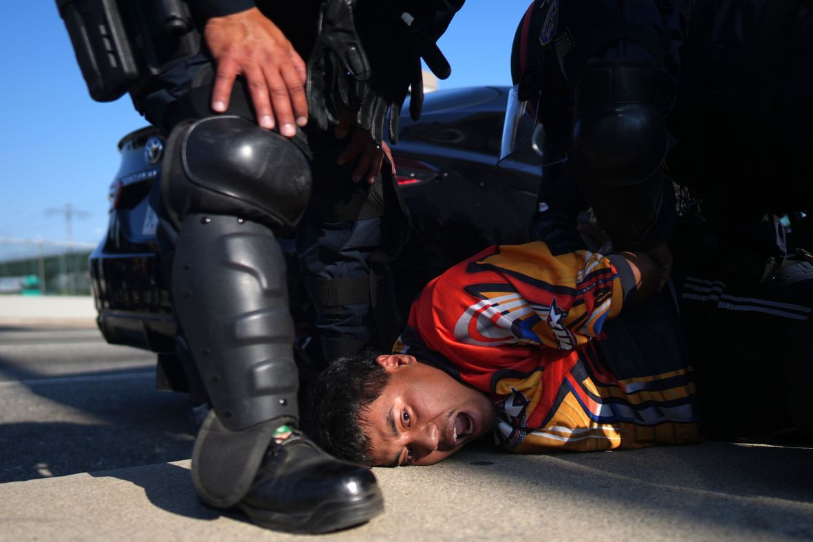 A protester is arrested by California Highway Patrol near the federal building in downtown Los Angeles on Tuesday.