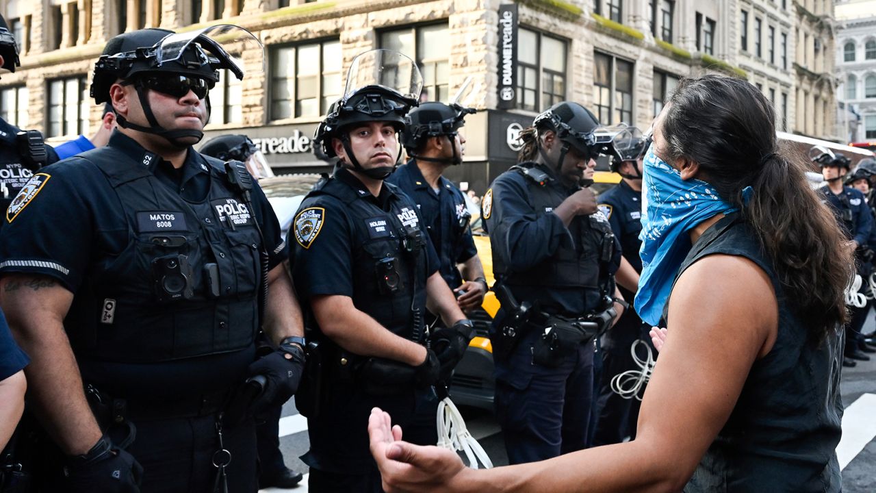 A demonstrator taunts NYPD officers at a protest against deportations by Immigration and Customs Enforcement outside the Jacob K. Javits Federal Building in New York, New York, on Monday, June 10, 2025.