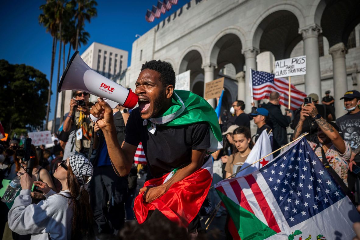A man shouts into a megaphone outside City Hall on Wednesday.
