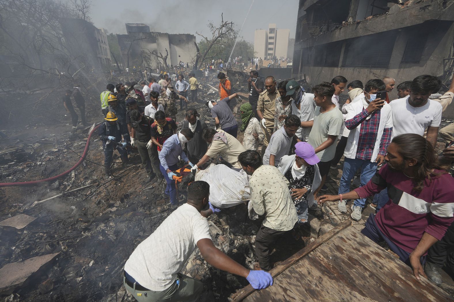 Rescuers carry a victim's body.