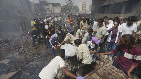 EDS NOTE GRAPHIC CONTENT- Rescuers carry the body of a victim of an airplane that crashed in India's northwestern city of Ahmedabad in Gujarat state, Thursday, June12, 2025. (AP Photo/Ajit Solanki)