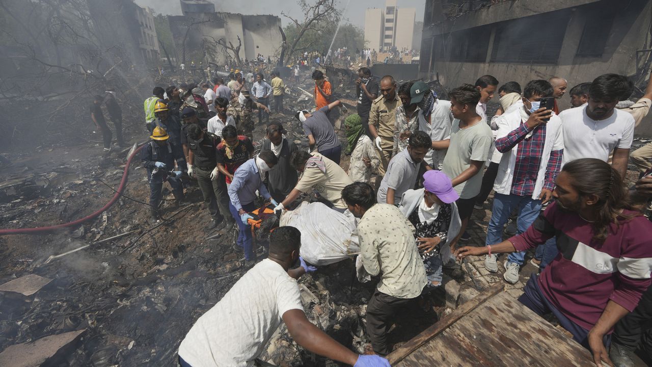 EDS NOTE GRAPHIC CONTENT- Rescuers carry the body of a victim of an airplane that crashed in India's northwestern city of Ahmedabad in Gujarat state, Thursday, June12, 2025. (AP Photo/Ajit Solanki)