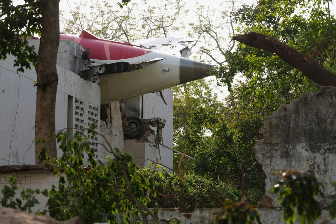The plane's tail is seen jutting out of a building...