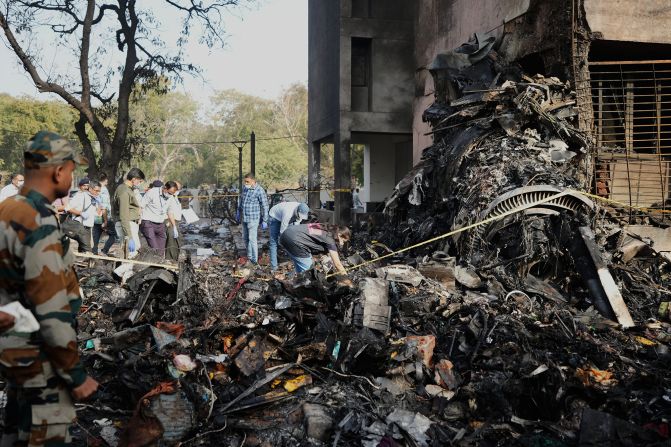 People work at the crash site.