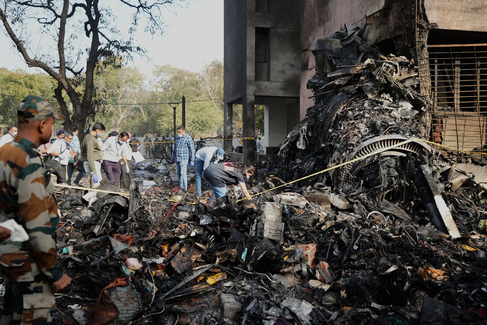 People work at the crash site.