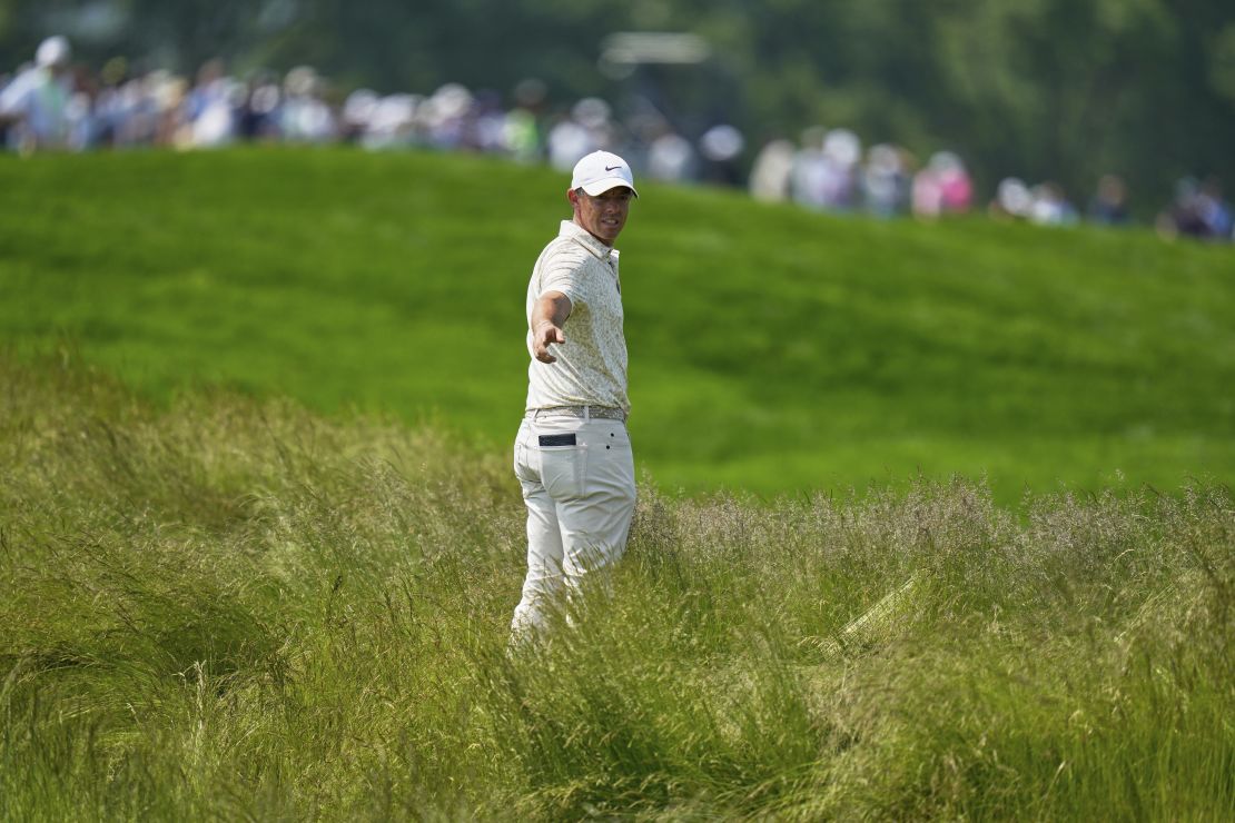 Rory McIlroy eyes up his options before playing out of the tall grass on the fourth hole at Oakmont.