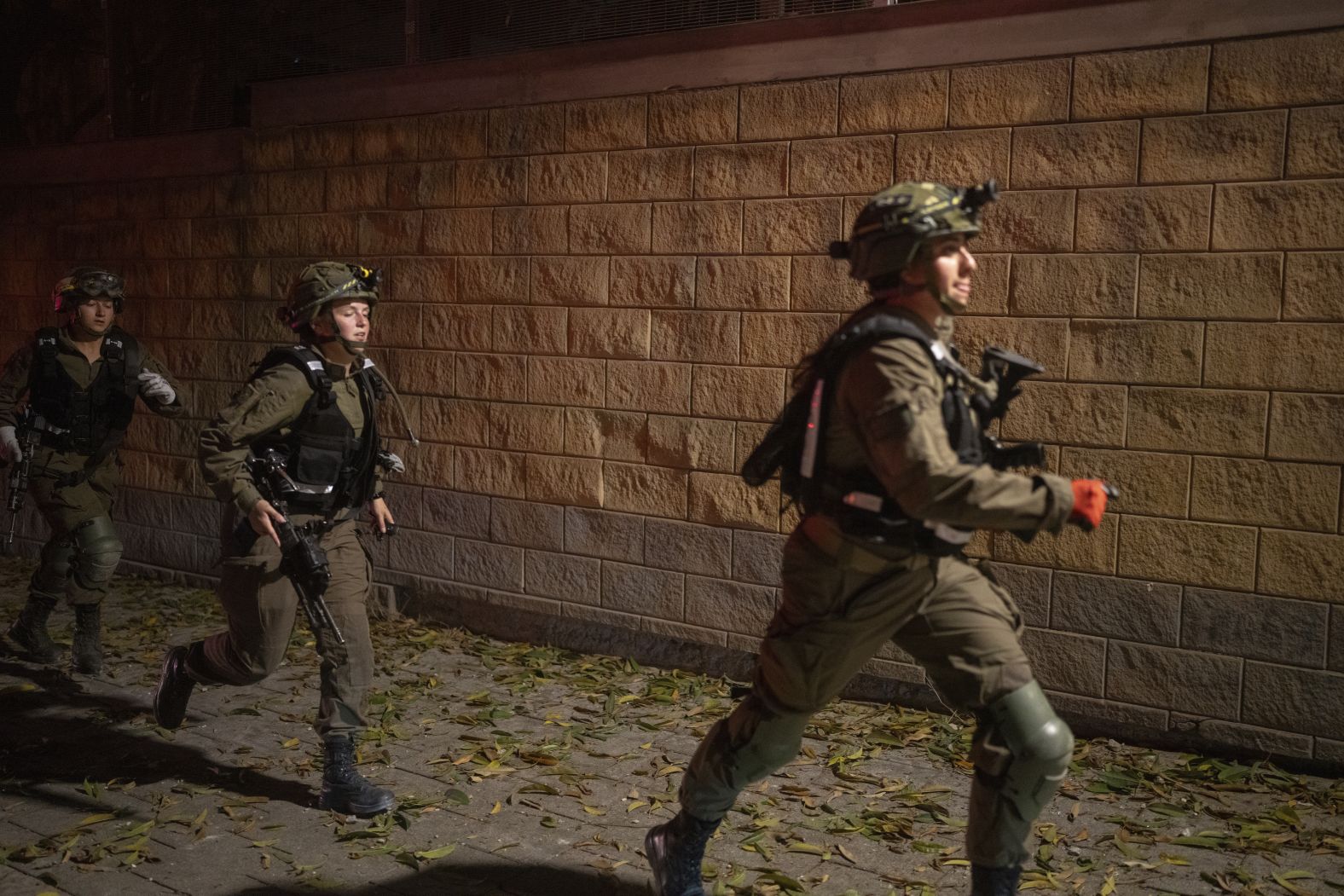 Police officers patrol the streets in Tel Aviv following an airstrike.