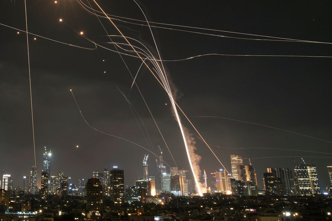 Projectiles will hit the building as Israeli iron dome air defense systems intercept missiles via Israeli Tel Aviv on Friday.