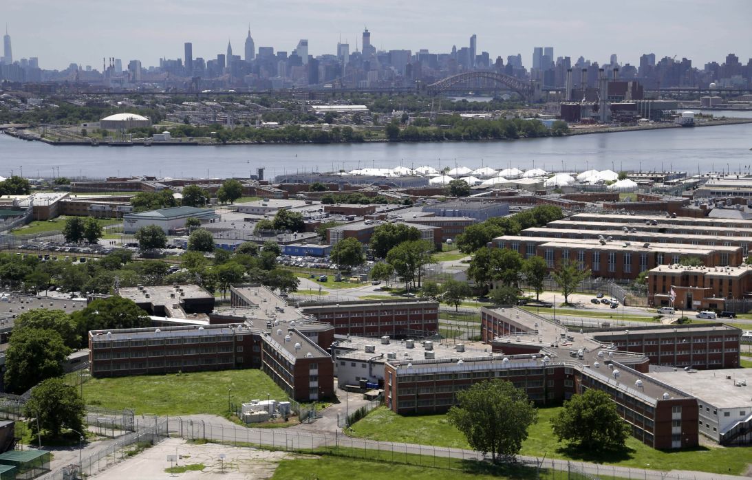 The Rikers Island jail complex stands in New York, with the Manhattan skyline in the background, June 20, 2014.