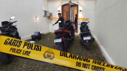Plain-clothed police officers are seen at a villa where a shooting that led to the death of an Australian man reportedly occurred, in Badung on the resort island of Bali, Indonesia, Saturday, June 14, 2025.