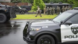 Law enforcement officers including local police, sheriffs and the FBI, stage less than a mile from a shooting in Brooklyn Park, Minn. on Saturday, June 14, 2025.