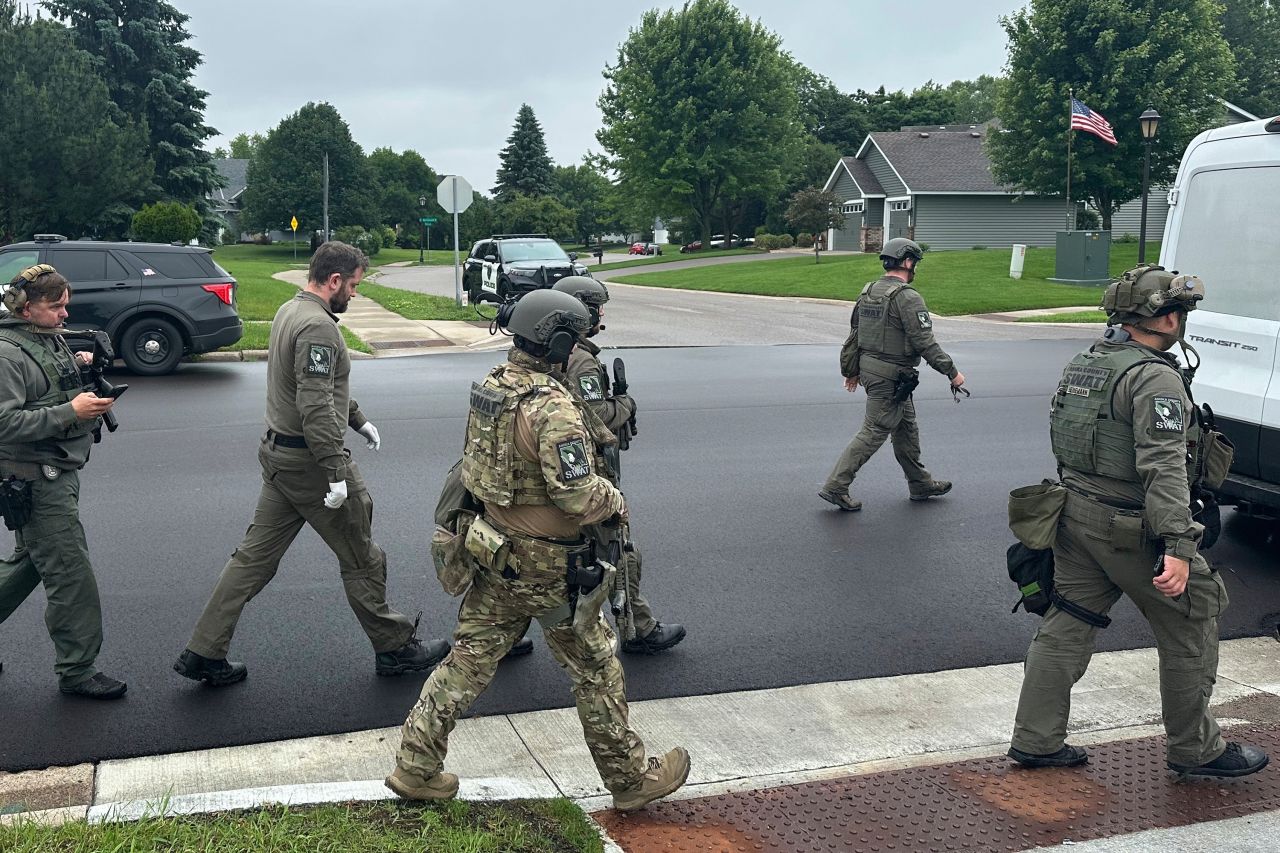 Police deploy as a manhunt is underway Saturday for the shooter who targeted two state lawmakers.