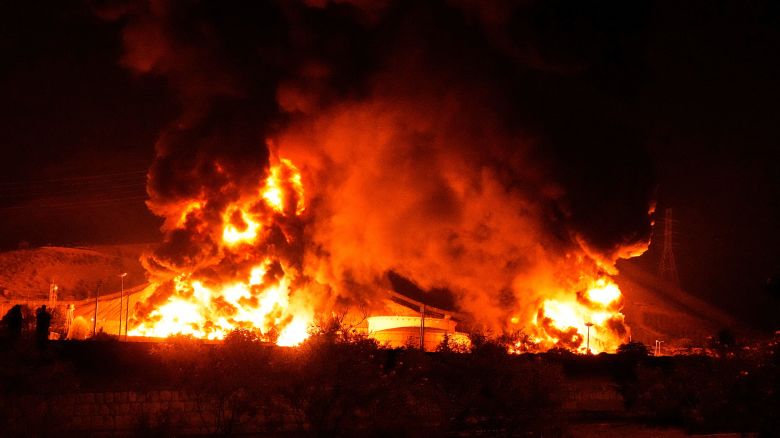 Flames rise from an oil storage facility after it was struck by an Israeli missile in Tehran, Iran, early Sunday, June 15, 2025. (AP Photo/Vahid Salemi)