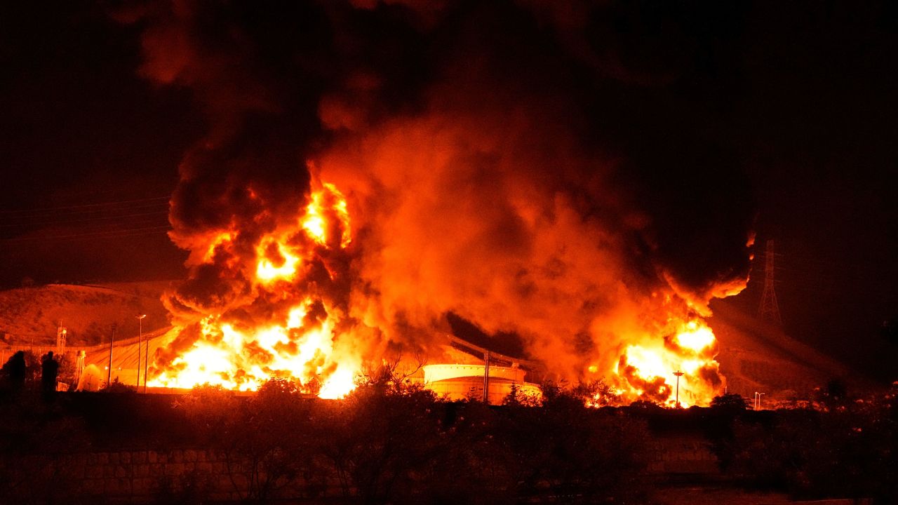 Flames rise from an oil storage facility after it was struck by an Israeli missile in Tehran, Iran, early Sunday, June 15, 2025. (AP Photo/Vahid Salemi)