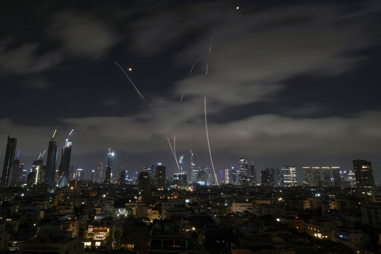 Israel's Iron Dome air defense system fires to intercept missiles over Tel Aviv, Israel, early Sunday.