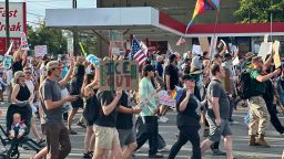 Demonstrators carry signs and chant while marching during a “No Kings” protest, in Salt Lake City. on Saturday, June 14, 2025.