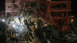 Israeli security forces inspect destroyed buildings that were hit by a missile fired from Iran, near Tel Aviv, Israel, Sunday, June 15, 2025.