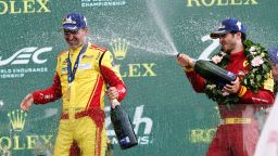 AF Corse car, a Ferrari 499P driver Robert Kubica, left, of Poland celebrates his win on the podium with third Ferrari AF Corse driver Antonio Giovinazzi of Italy, on the podium after winning the 24-hour Le Mans endurance race, Sunday June 15, 2025 in Le Mans, western France. (AP Photo/Jeremias Gonzalez)