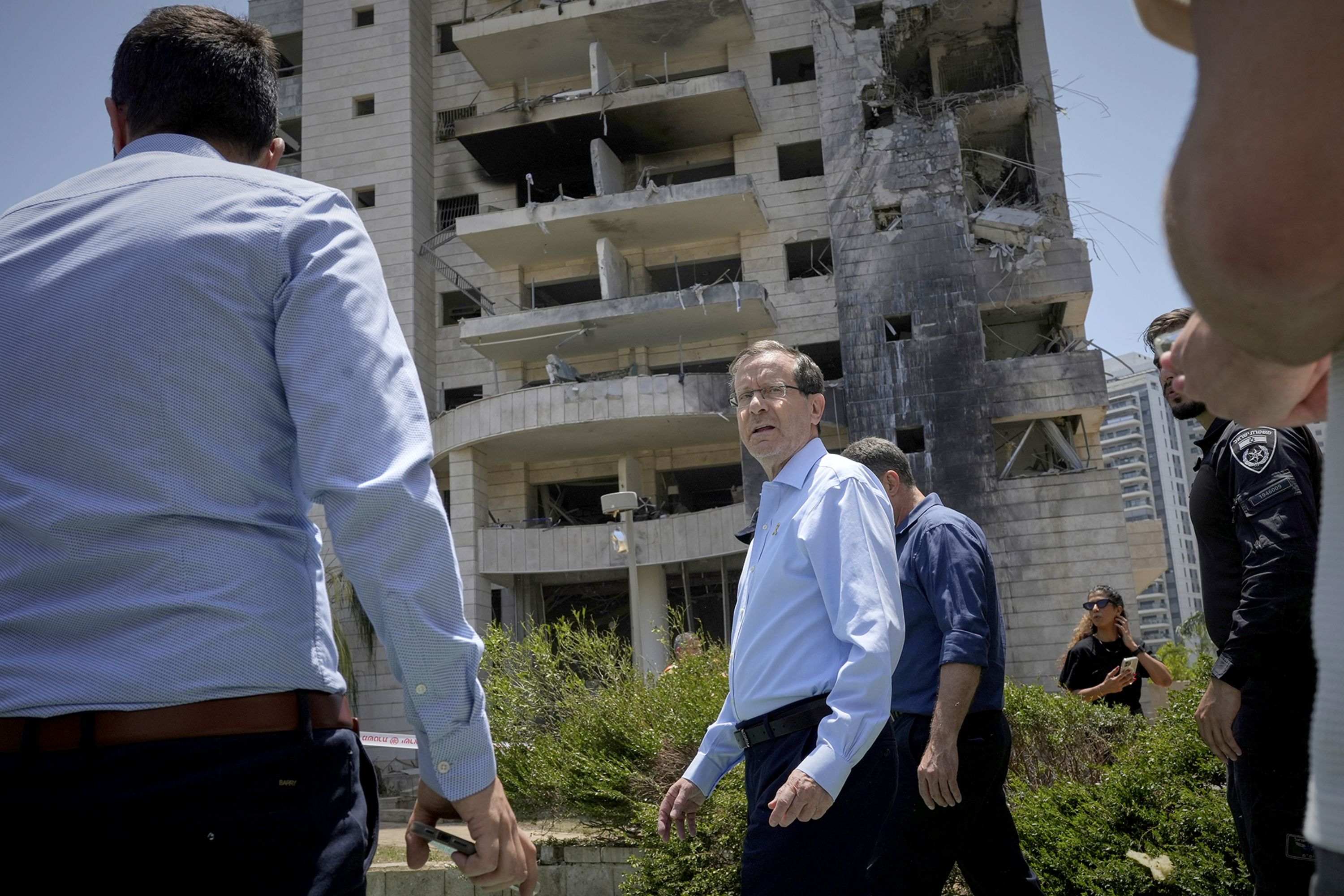 Israeli President Isaac Herzog visits a residential building struck by a missile launched from Iran, in Petah Tikva, Israel, on Monday, June 16.