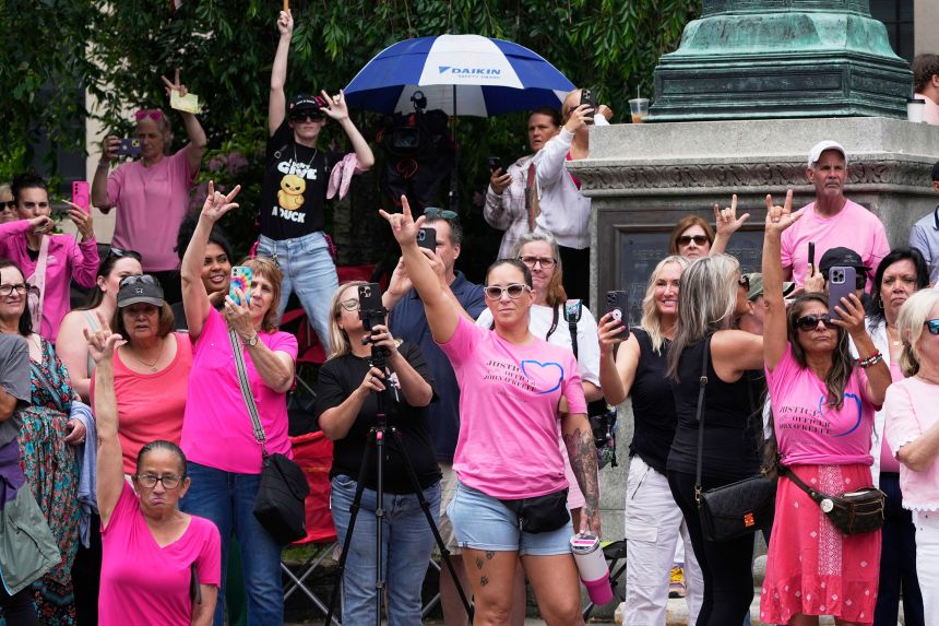 Supporters of Karen Read gesture as Read departs Norfolk Superior Court during jury deliberations at her trial, Tuesday in Dedham.