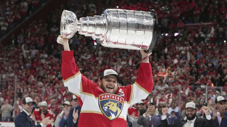 Florida Panthers captain Aleksander Barkov (16) raises the Stanley Cup after defeating the Edmonton Oilers in Game 6 of the NHL hockey Stanley Cup Final Tuesday, June 17, 2025, in Sunrise, Florida.