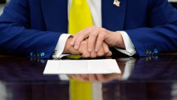 President Donald Trump's hands rest on the Resolute Desk in the Oval Office of the White House, Wednesday, June 18, 2025, in Washington. (AP Photo/Alex Brandon)