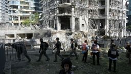 Rescue workers and military personnel inspect the site of a direct hit from an Iranian missile strike in Ramat Gan, Israel, Thursday, June 19, 2025. (AP Photo/Oded Balilty)