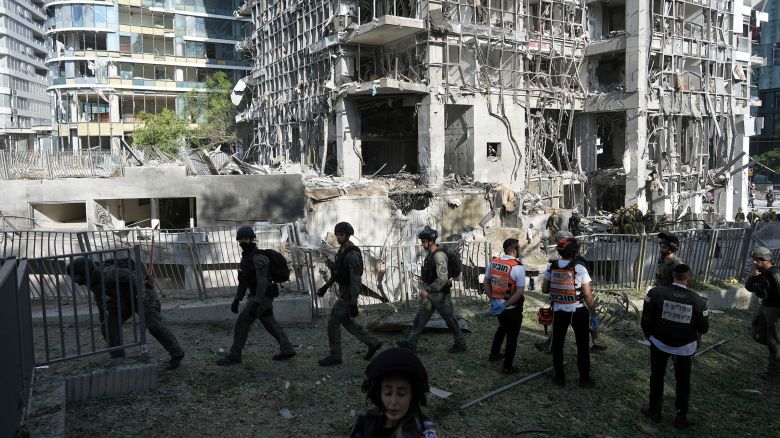 Rescue workers and military personnel inspect the site of a direct hit from an Iranian missile strike in Ramat Gan, Israel, Thursday, June 19, 2025. (AP Photo/Oded Balilty)