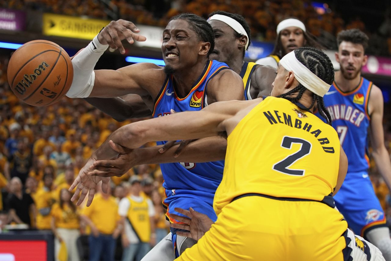 Oklahoma City's Jalen Williams loses the ball as he's guarded by the Pacers' Andrew Nembhard.