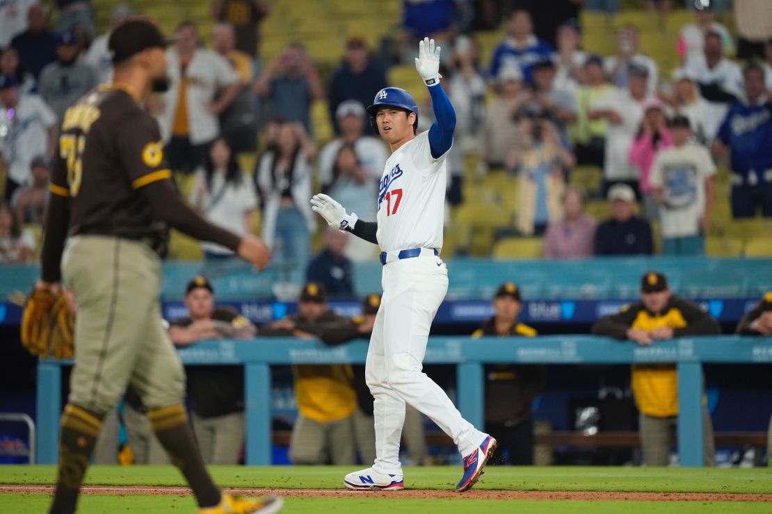Dodgers superstar Shohei Ohtani waves off teammates after getting hit by a pitch in the ninth inning.