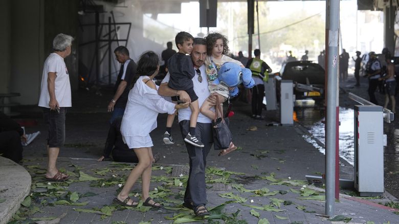 People evacuate after a missile launched from Iran struck in Haifa, Israel, Friday, June 20, 2025. (AP Photo/Baz Ratner)