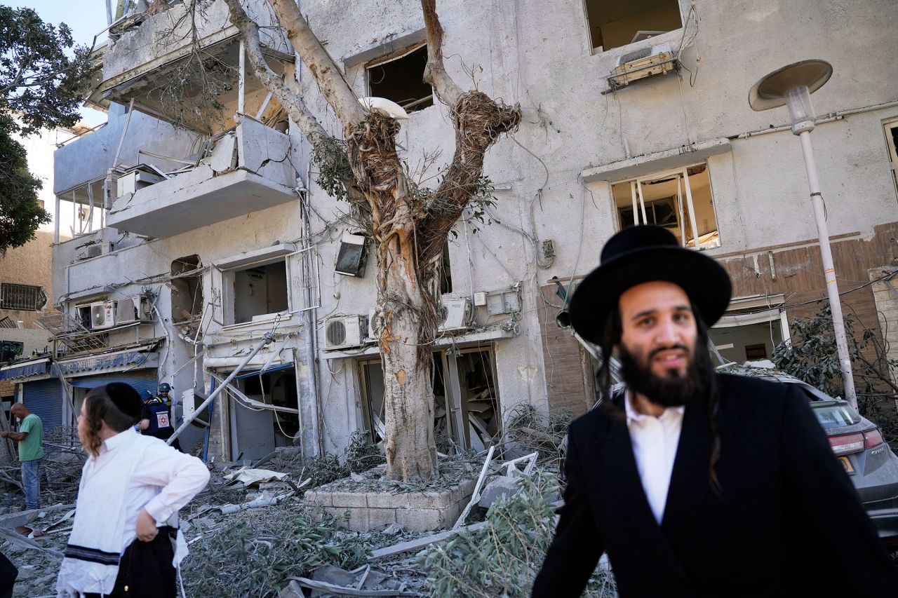Residents evacuate from the site in Haifa, Israel, following an Iranian missile strike on Sunday.