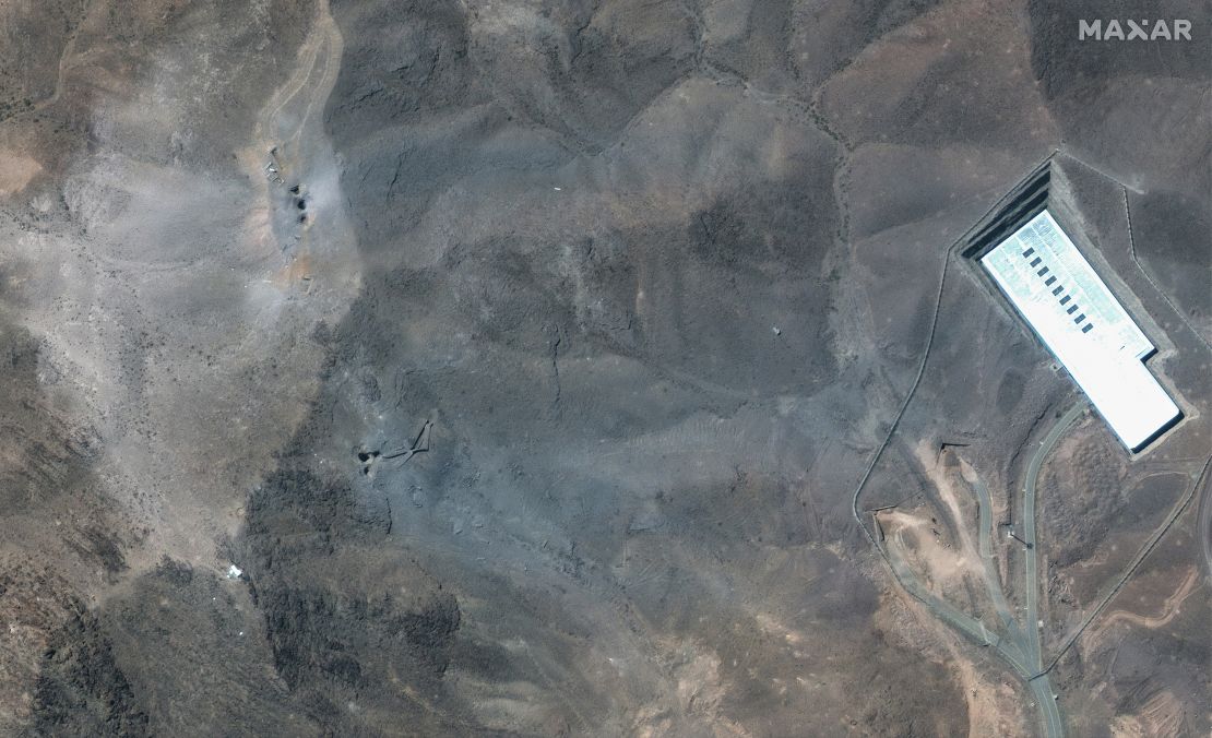This satellite image provided by Maxar Technologies shows a closer view of craters and ash on a ridge at Fordo enrichment facility in Iran after US strikes.