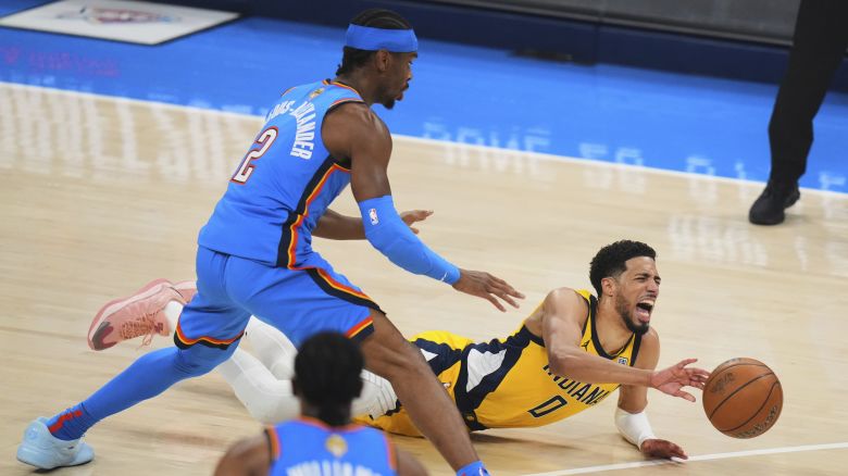 Indiana Pacers guard Tyrese Haliburton (0) falls to the court with an injury during the first half of Game 7 of the NBA Finals basketball series against the Oklahoma City Thunder Sunday, June 22, 2025, in Oklahoma City. (AP Photo/Nate Billings)