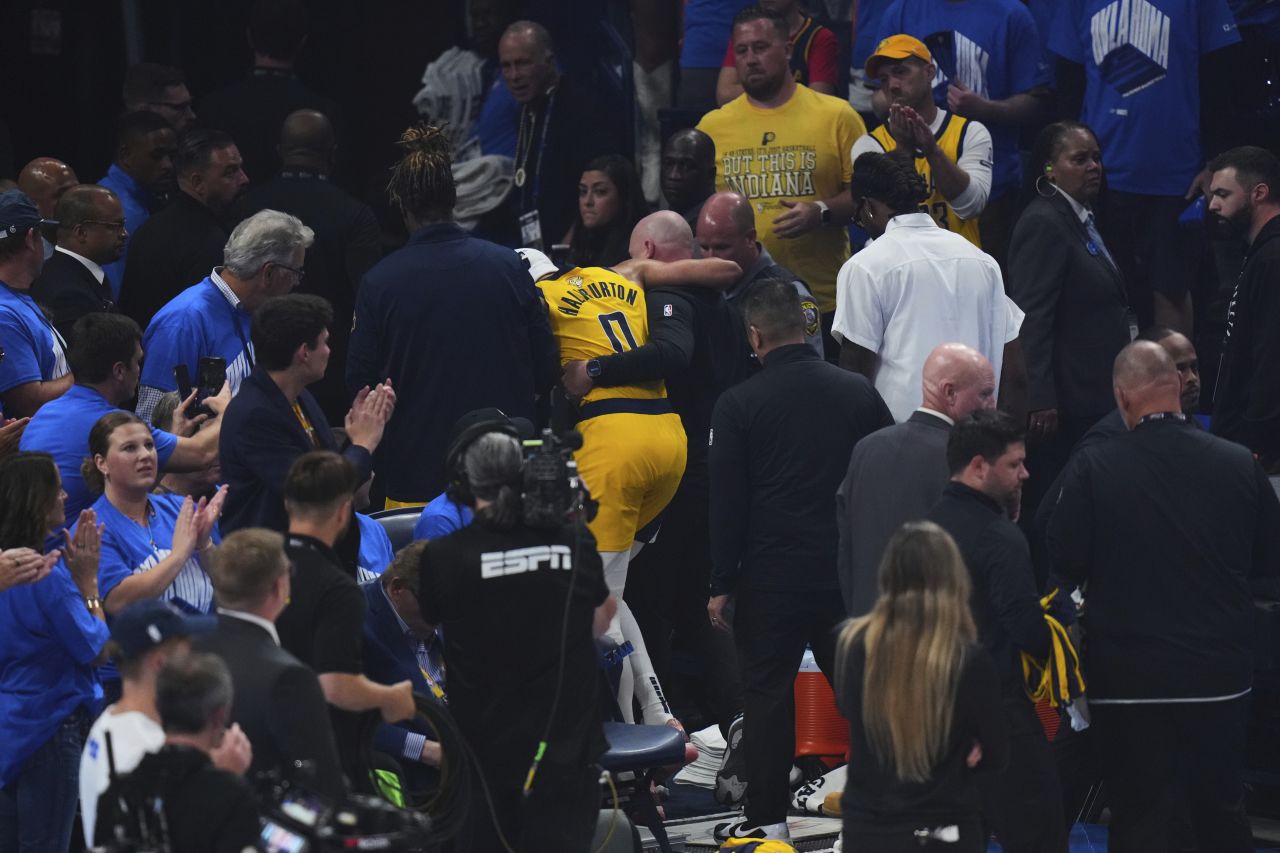 Pacers star Tyrese Haliburton is helped off the court in the first half.