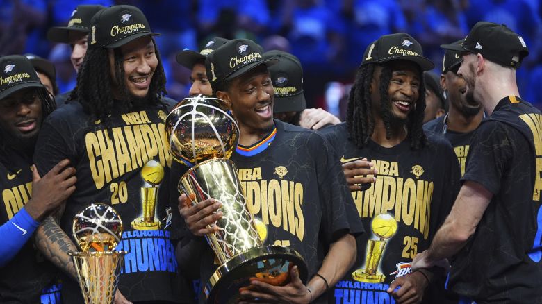 Oklahoma City Thunder forward Jalen Williams (8) holds the Larry O'Brien Championship Trophy as he celebrates with his team after they won the NBA basketball championship with a Game 7 victory against the Indiana Pacers Sunday, June 22, 2025, in Oklahoma City. (AP Photo/Julio Cortez)