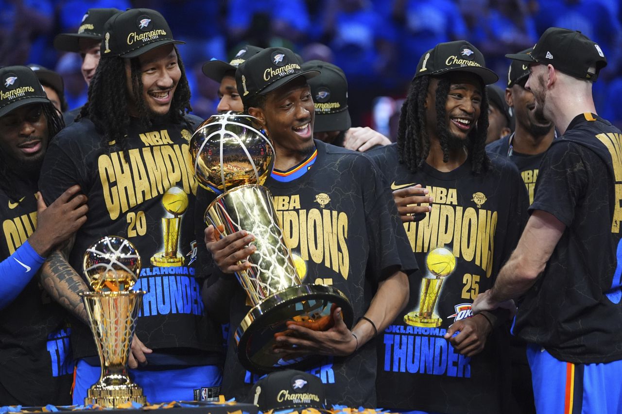 Jalen Williams holds the Larry O'Brien Championship Trophy.