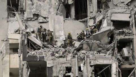 Israeli soldiers and rescue team search for survivors amid the rubble of residential buildings destroyed by an Iranian missile strike that killed several people, in Beersheba, Israel, on Tuesday, June 24, 2025. (AP Photo/Leo Correa)