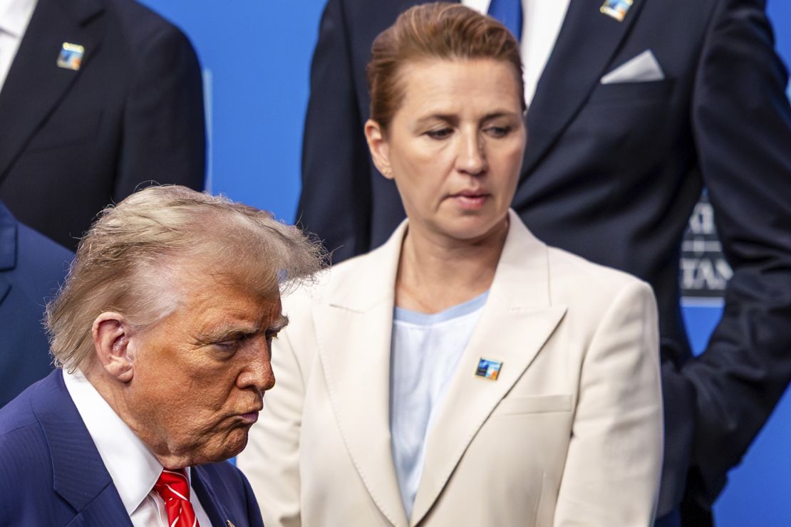 US President Donald Trump, left, walks by Denmark's Prime Minister Mette Frederiksen prior to a group photo of NATO heads of state and government in The Hague, Netherlands, on June 25, 2025.