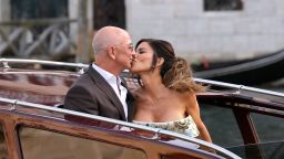 Jeff Bezos, center left, and Lauren Sanchez, center right, kiss as they leave a hotel for their pre wedding reception, in Venice, Italy, Thursday, June 26, 2025. (AP Photo/Luca Bruno)
