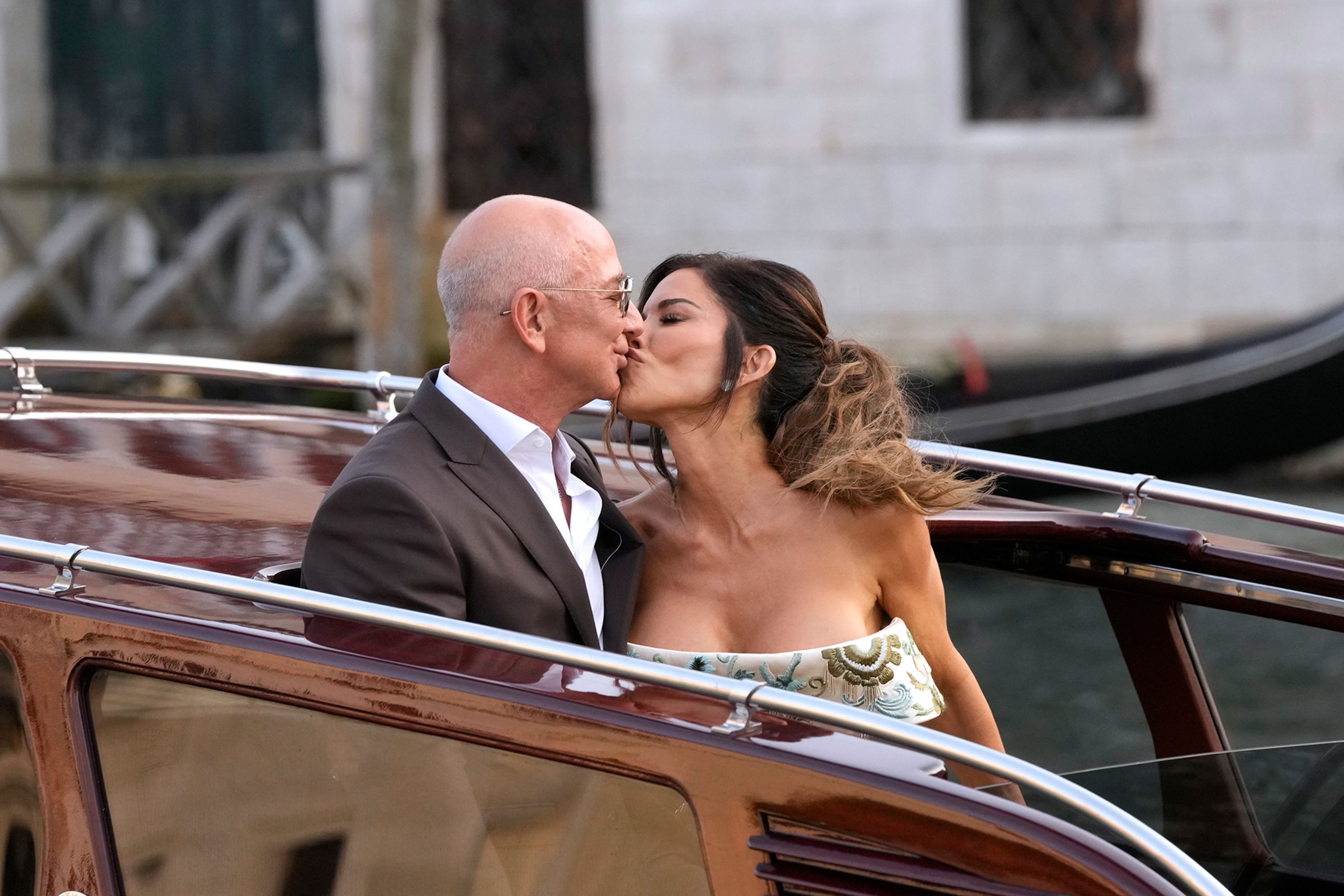 Jeff Bezos and Lauren Sanchez kiss as they leave the Aman hotel in Venice, Italy, for their pre-wedding reception on Thursday, June 26.