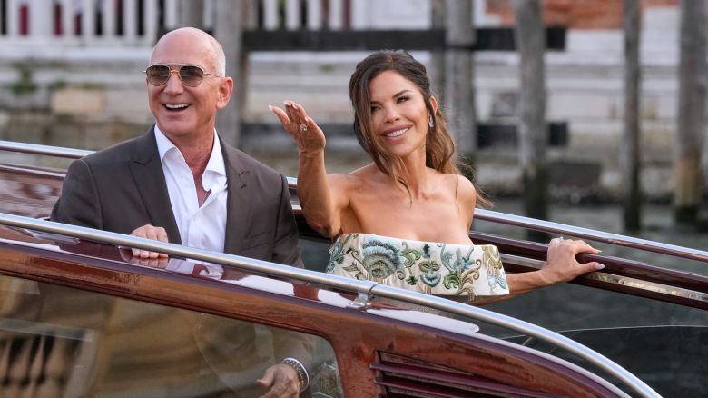 Jeff Bezos, left, and Lauren Sanchez leave a hotel for their pre-wedding reception, in Venice, Italy, Thursday, June 26, 2025. (AP Photo/Luca Bruno)