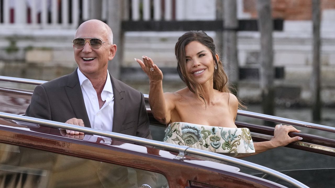 Jeff Bezos, left, and Lauren Sanchez leave a hotel for their pre-wedding reception, in Venice, Italy, Thursday, June 26, 2025.