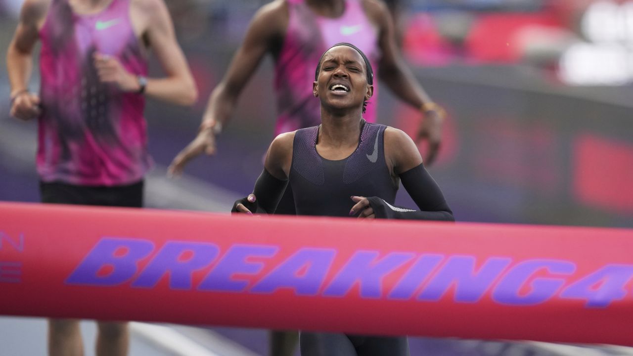 Faith Kipyegon, from Kenya, approaches the finish line in her attempt to become the first woman to run a mile in under four minutes.