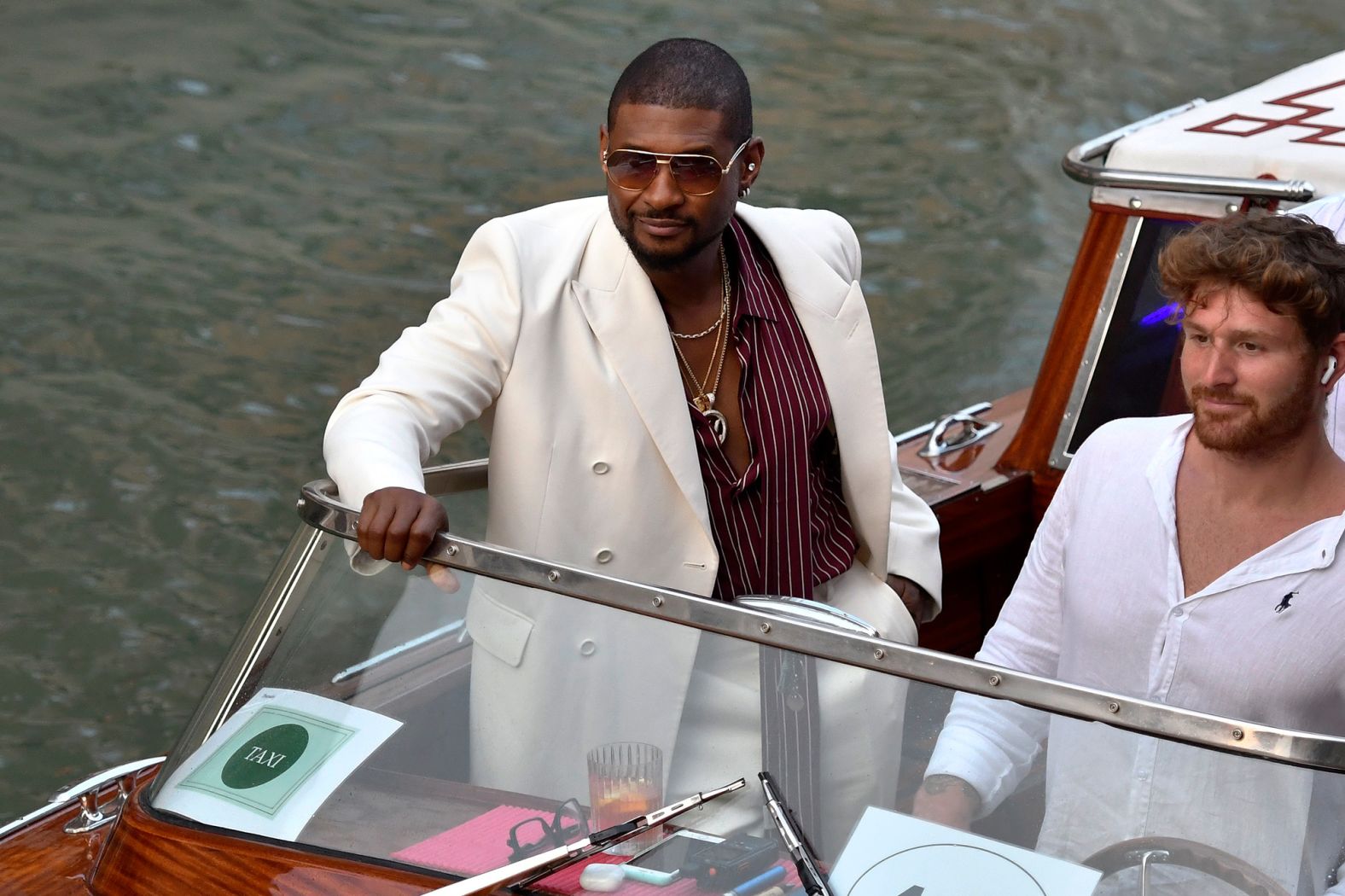 Usher rides on a boat taxi on Thursday.