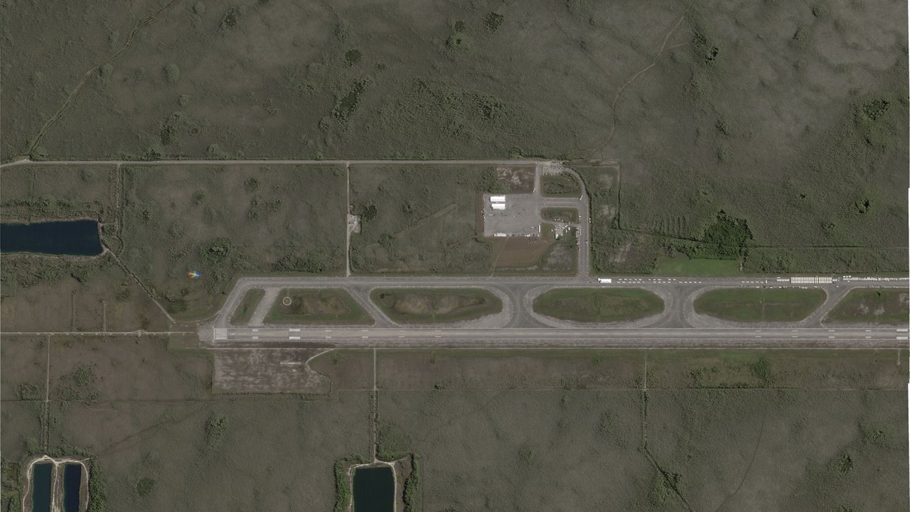This satellite photo captured by Planet Labs PBC on June 25, 2025, shows white structures cropping up on an airstrip in Ochopee, Fla., in the Everglades, where state officials are building an immigration detention facility. (Planet Labs PBC via AP)